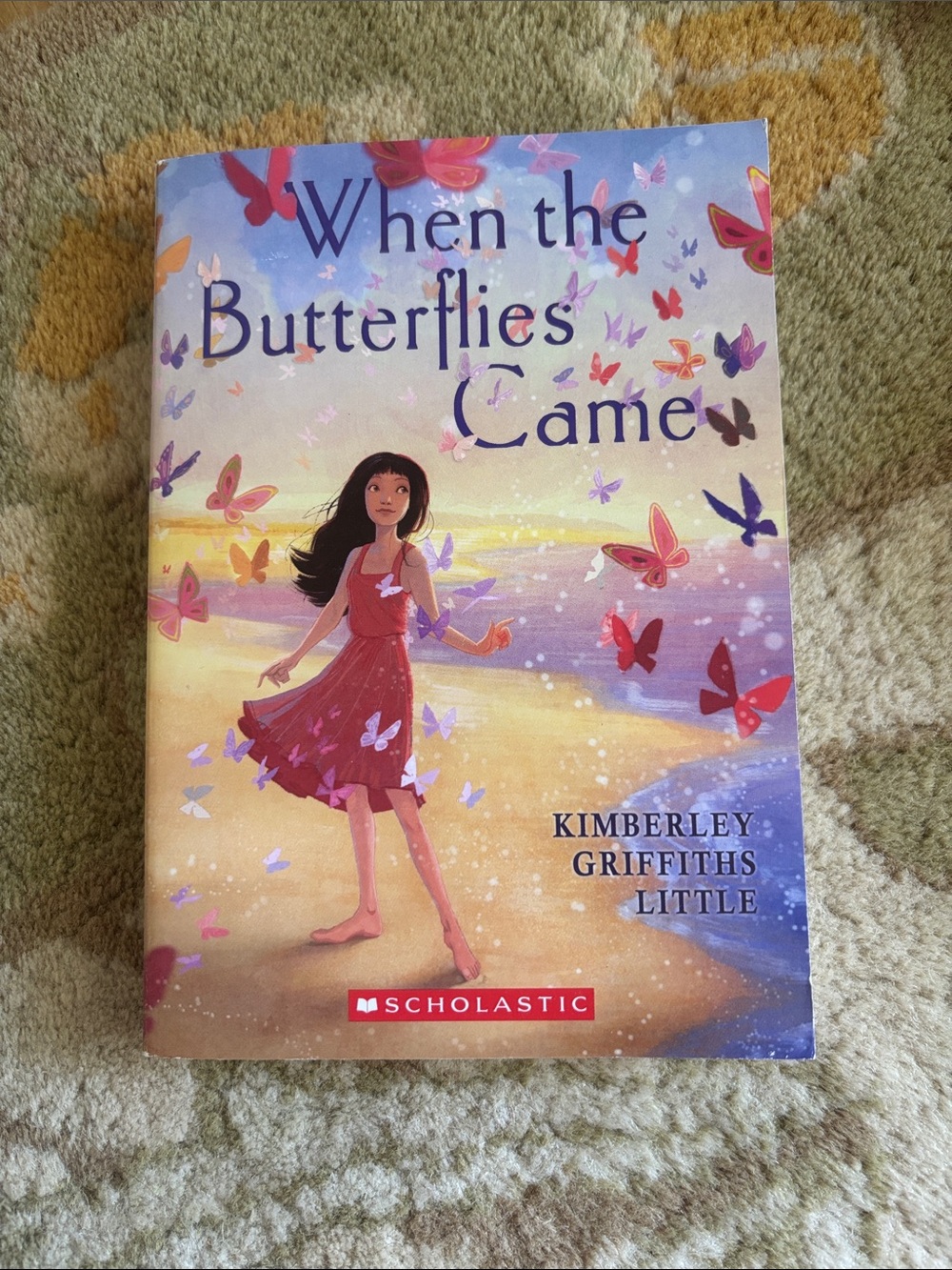 Scholastic children's book with pink dress and multicolored butterflies
